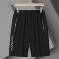 Man wearing black loose-fit quick-drying nylon sports shorts for summer activity.