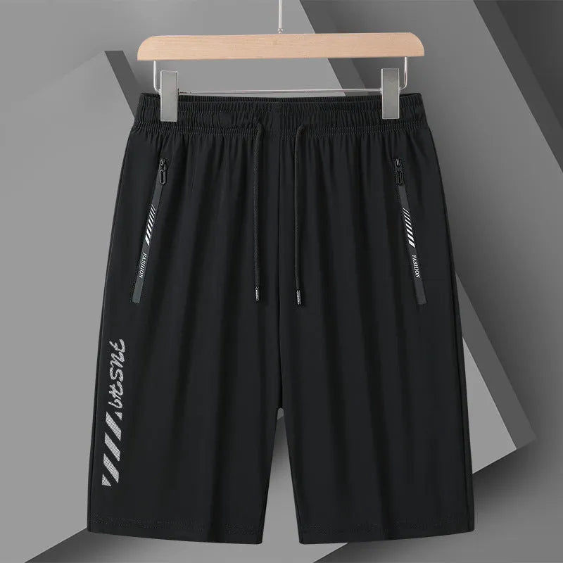 Man wearing black loose-fit quick-drying nylon sports shorts for summer activity.