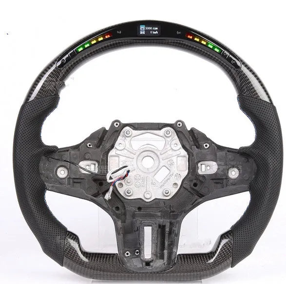 Black carbon fibre BMW sports steering wheel with integrated LED multifunctional display.