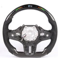 Black carbon fibre BMW sports steering wheel with integrated LED multifunctional display.