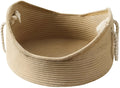 Wicker-style cat bed basket with a corrugated scratching board inside.