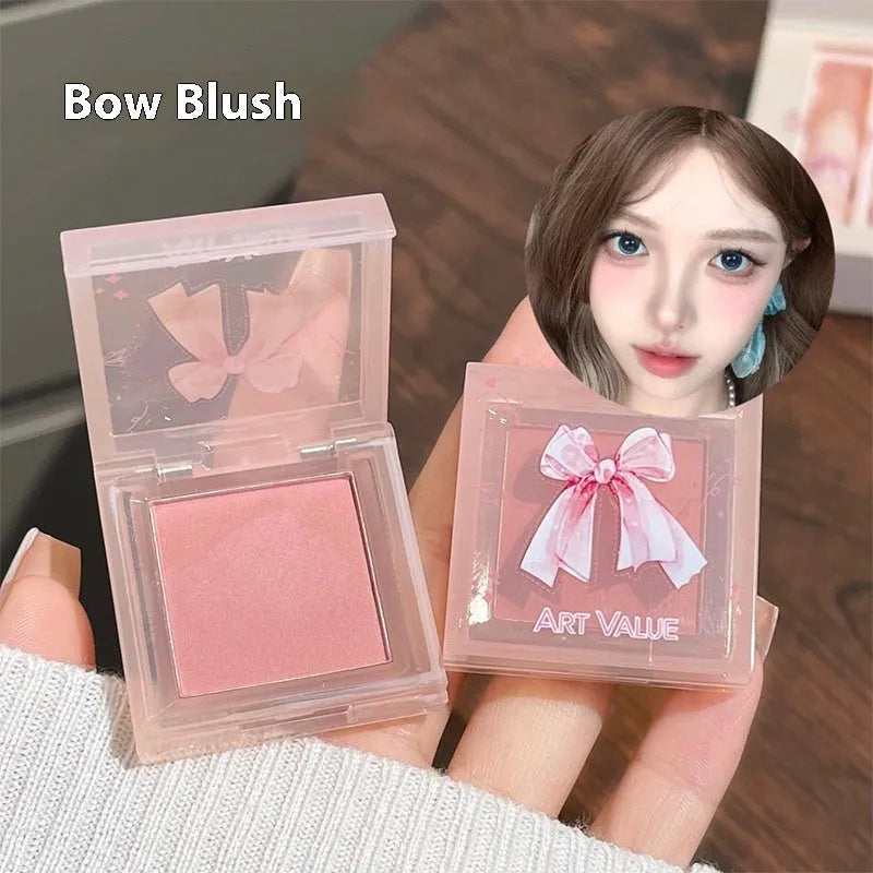 Butterfly Box makeup set showing four pink lip muds, a powder blusher, and a necklace