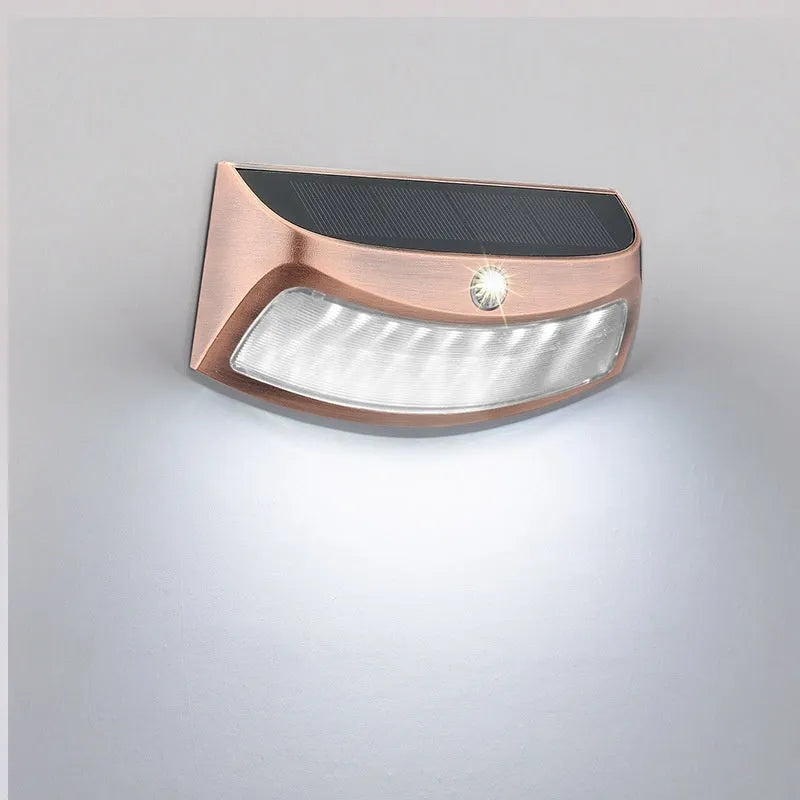 Solar-powered decorative wall lamp with smiling face design for outdoor garden lighting