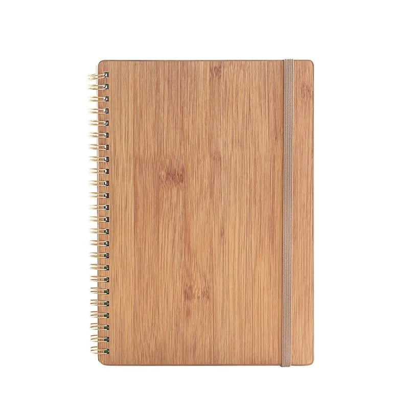 Erasable coil-bound notebook with stone paper, shown with pen and cloth on a wooden desk.