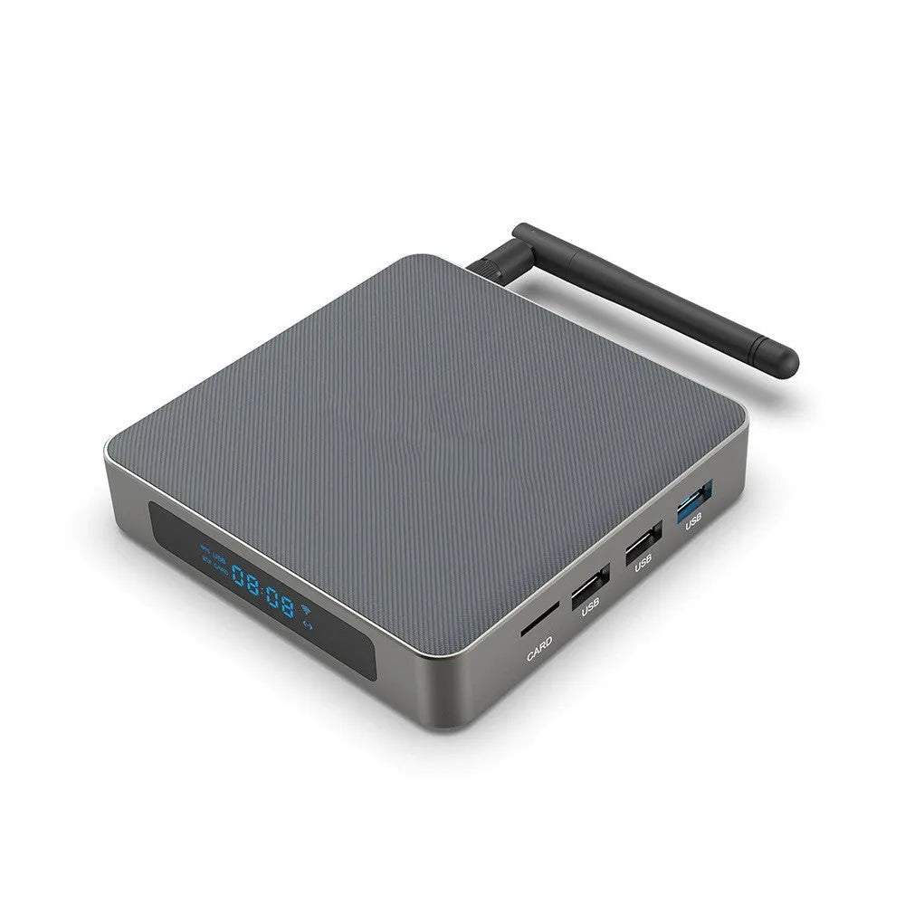 Black Android 8K set-top box with remote control, HDMI cable, and UK plug on a wooden surface.
