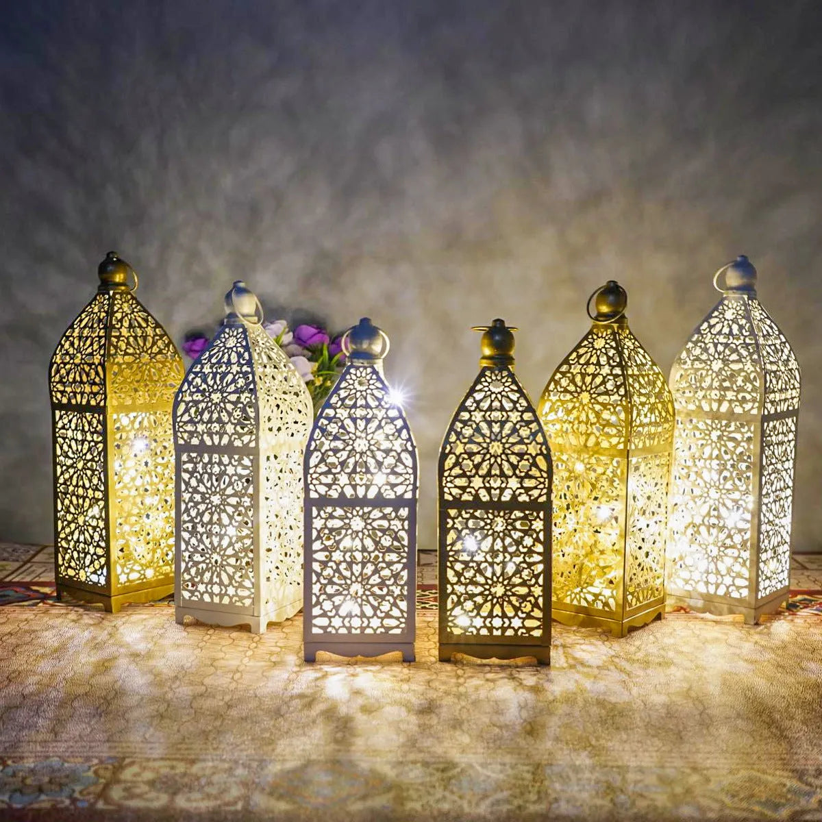 Gold L decorative iron barn lantern with hollow four-corner design on a tabletop