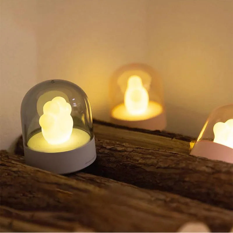 Cat paw-shaped night light with music box function showing pink colour option with illuminated soft light