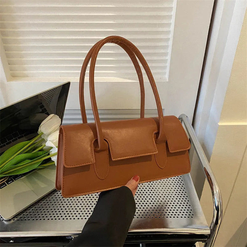 Women's small square shoulder bag in PU material showing stitching details and horizontal shape
