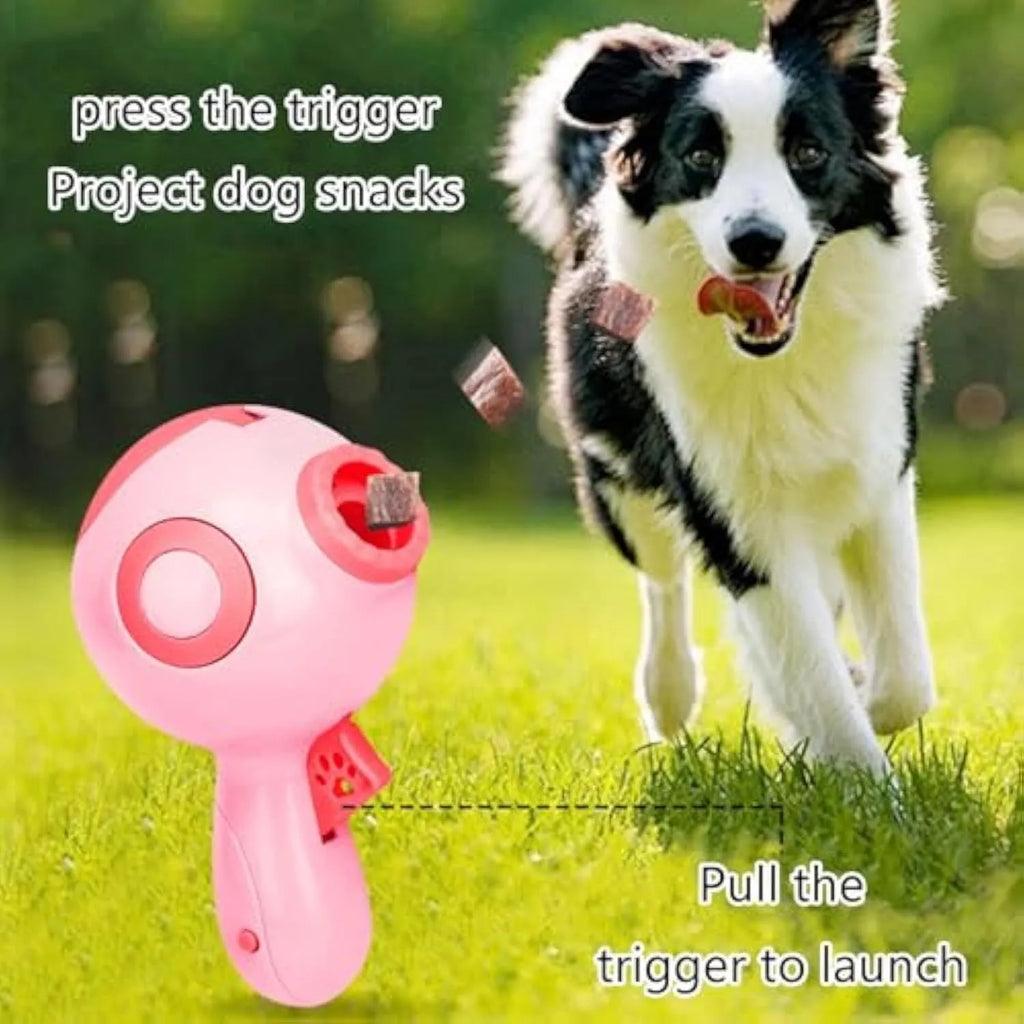 Green, orange, and pink plastic dog treat launcher toy for interactive feeding and training.