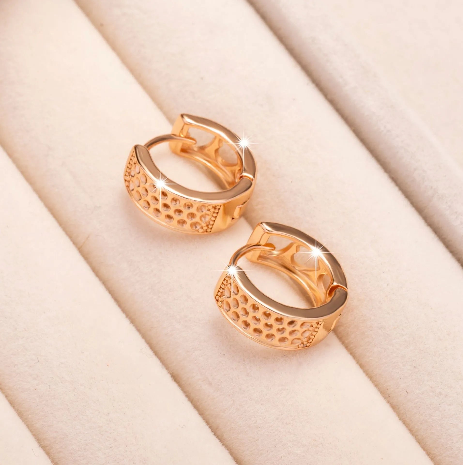 Rose gold hollow heart earrings with three open sections and circular shape