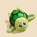 Grey turtle-shaped knot toy for dogs with a built-in squeaker on a plain background