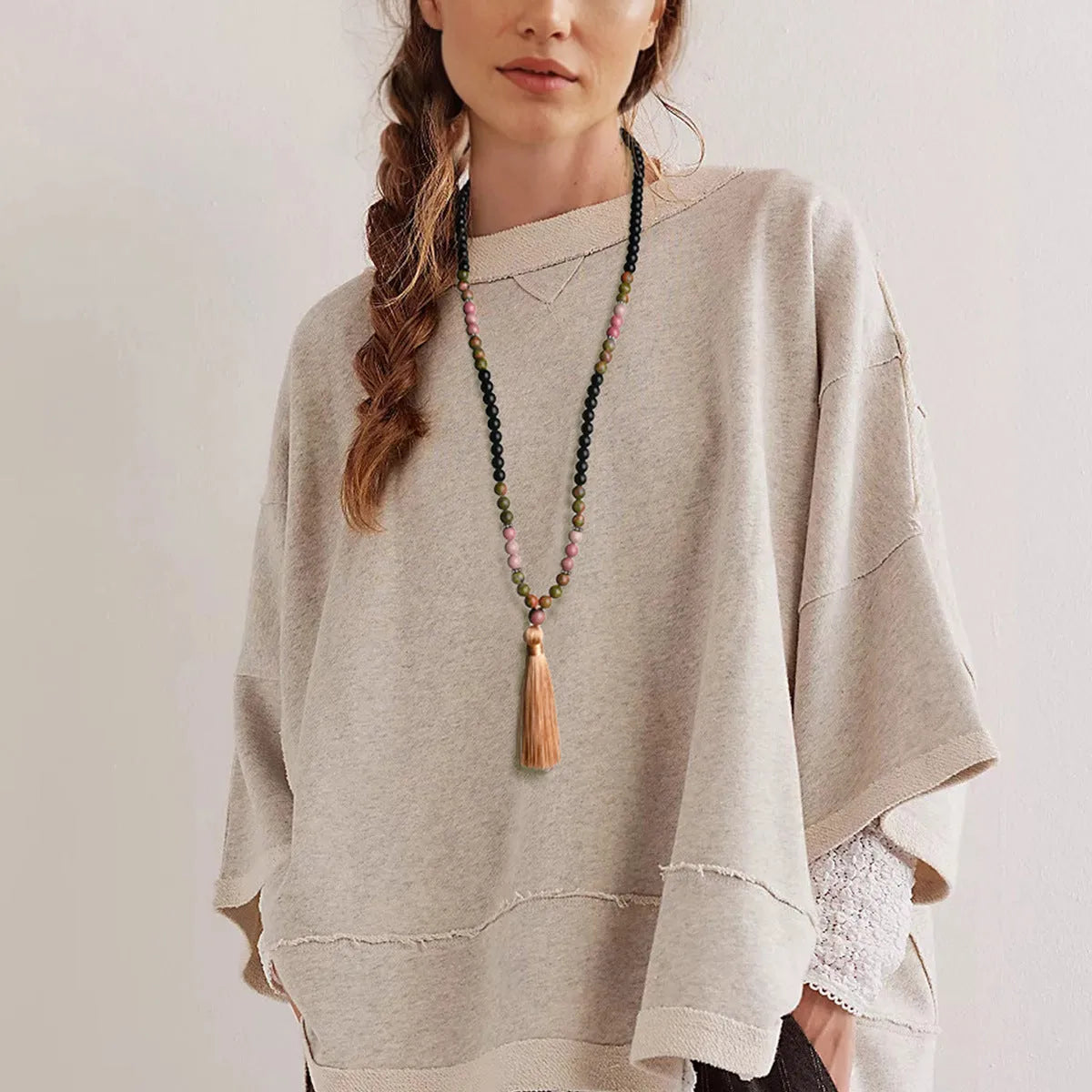 Long bohemian necklace with 108 stone tassels and a geometric gemstone pendant on an 81cm chain.