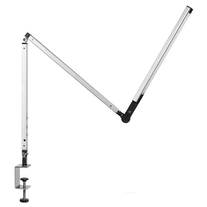 Aluminium LED desk lamp with clip base and remote control on a wooden desk.
