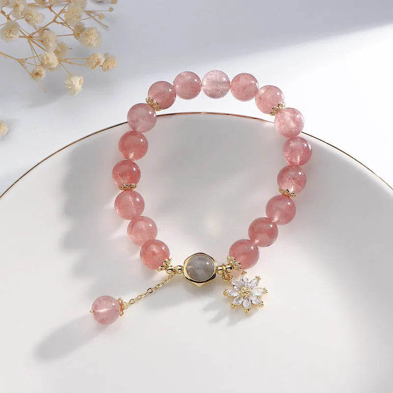 Strawberry quartz Mori style bracelet with electroplated floral details on a white background