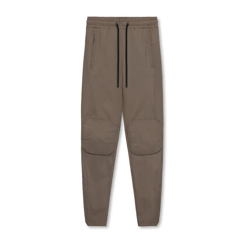 Men's grey loose-fit fitness trousers with ankle ties and quick-drying polyester fabric