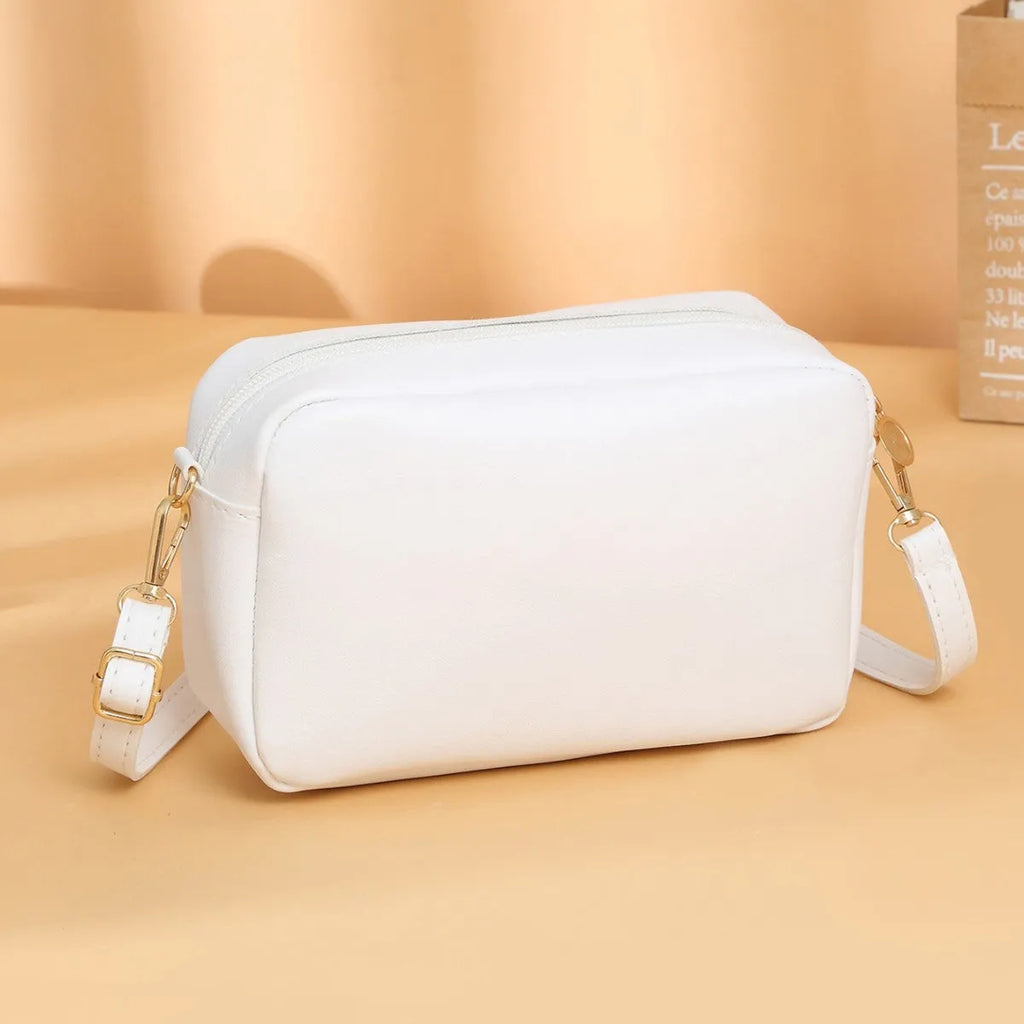 Women's PU shoulder bag in horizontal square shape with three-dimensional pocket, shown in solid colour options.