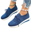 Women's low-top fly-knit sneakers in red with front lace-up closure and round toe.