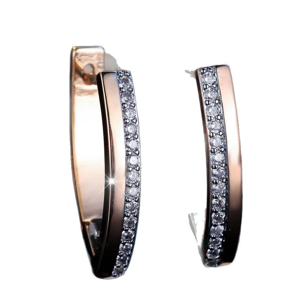 Geometric V-shaped women's earrings in champagne gold white diamond colour.