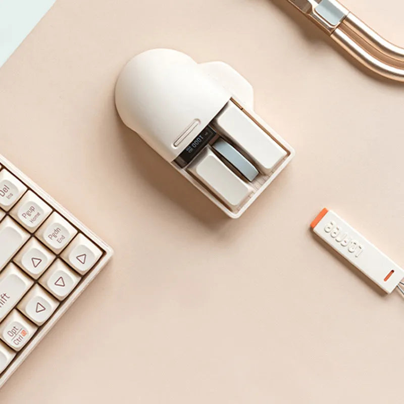 Tofu coloured wireless computer mouse with programmable buttons and scroll wheel on plain background