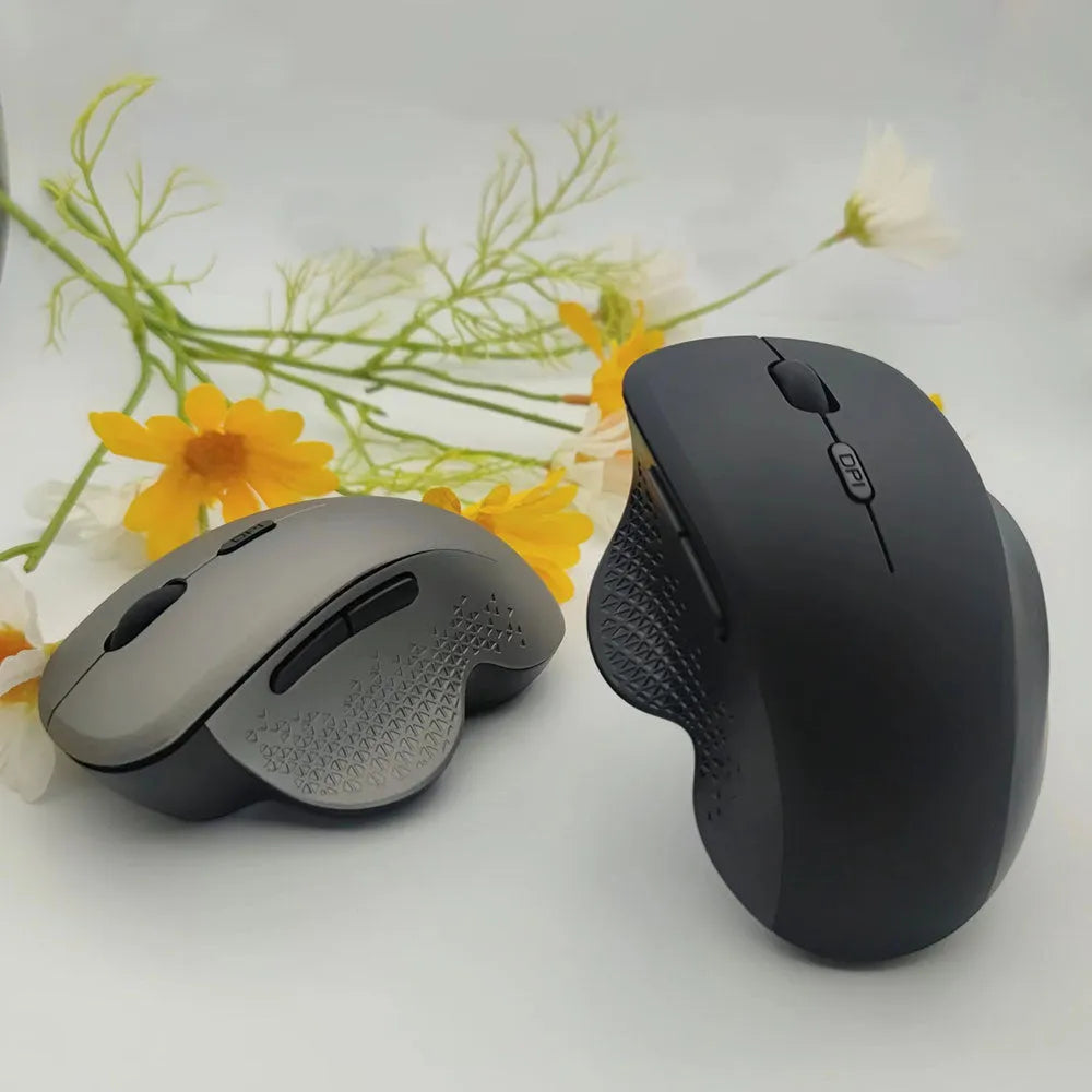Grey wireless charging mouse for laptops with USB cable on white background