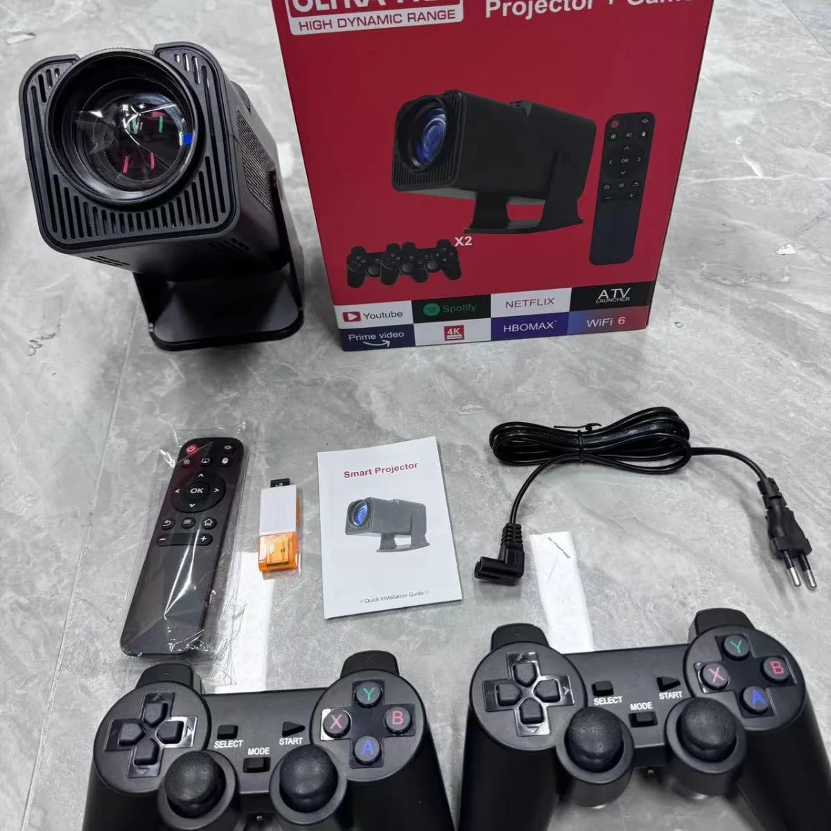 White home projector with carrying handle on a table, set up for wireless gaming projection.