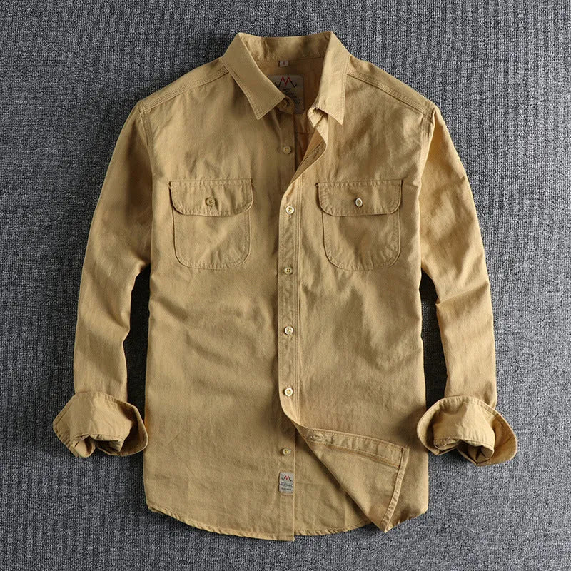 Men's solid colour long sleeve cotton shirt in cardigan style on a hanger.