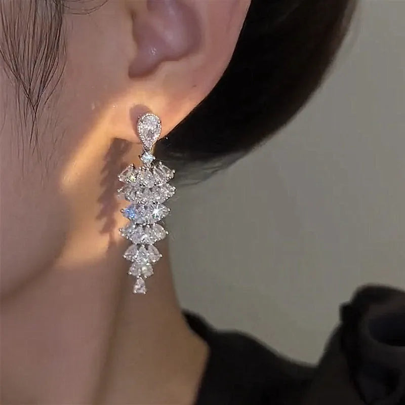 Women's silver pagoda Christmas tree drop earrings with a dangling zircon star on copper studs.