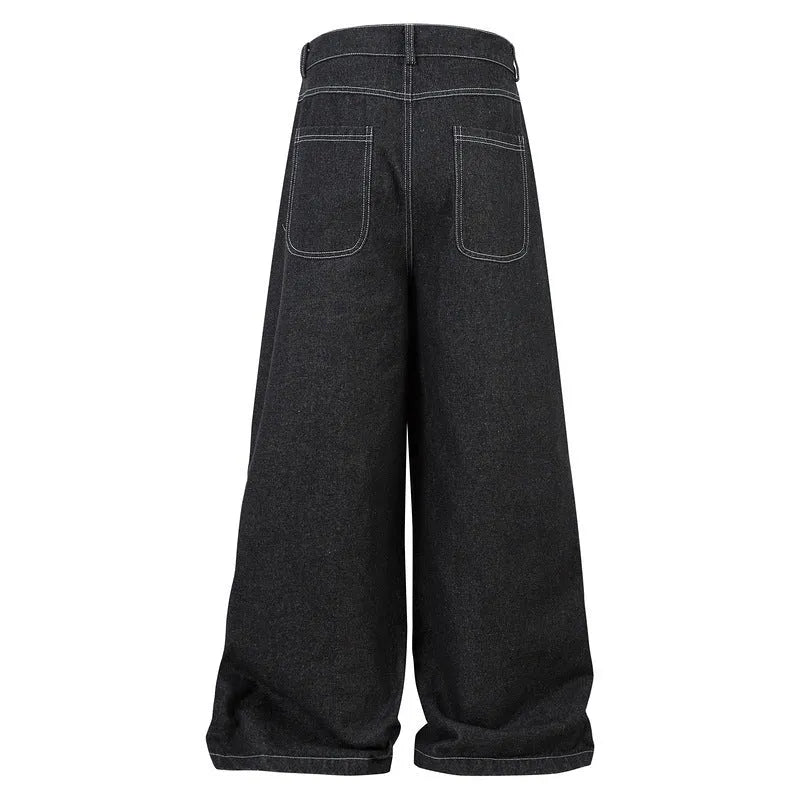 Black multi-pocket pleated workwear jeans made from cotton denim on a plain background.