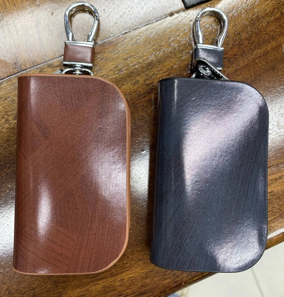 Genuine leather car key case with frosted finish in black and brown colours.
