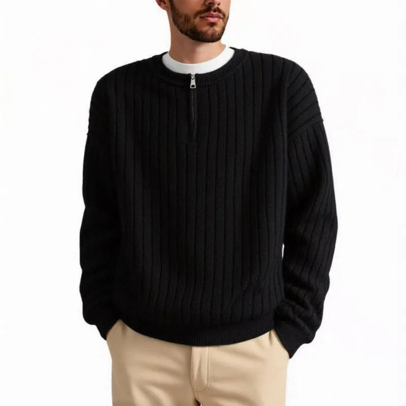 Man wearing a grey half-zip textured knit pullover sweater with a loose fit.