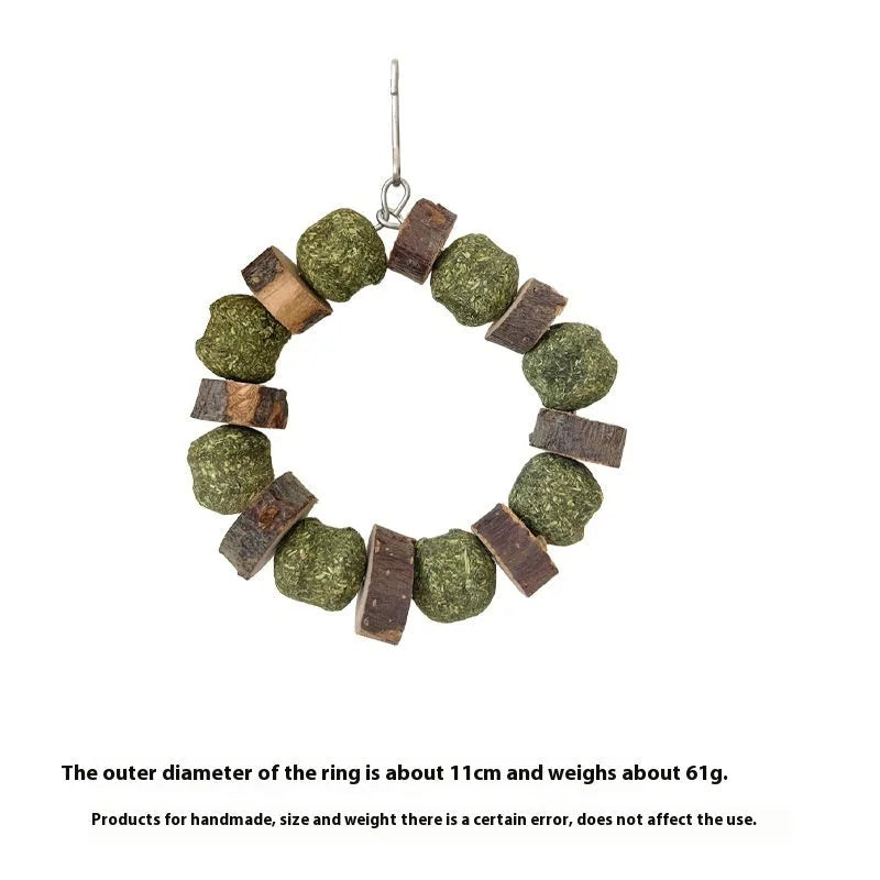 Hamster chew toy with Applewood stick and woven straw ball ring on a white background.