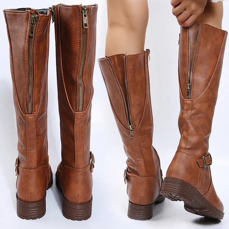 Women's black knight boots with a square heel, high shaft, and a front belt buckle fastening.