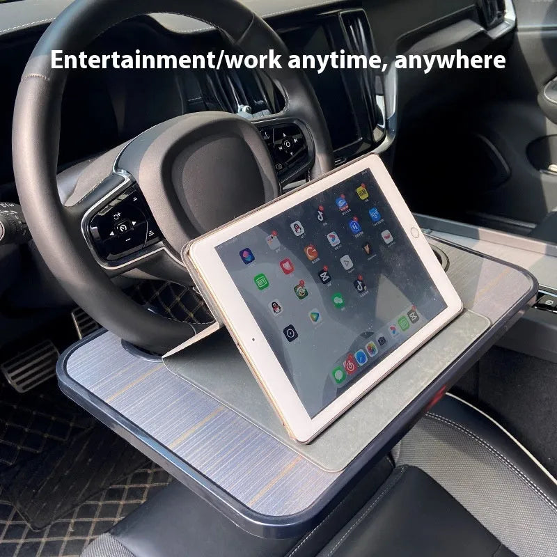 Black ABS car steering wheel tray holding a laptop, with a foldable drink cup holder attached.