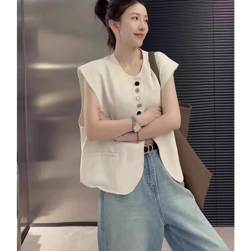 Women's loose fit polyester vest in milky white colour with pockets, shown on hanger