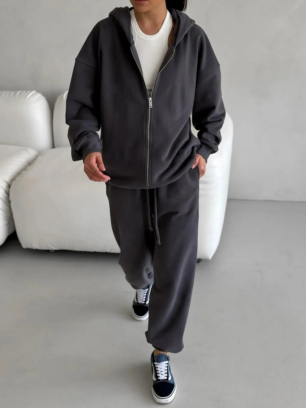 Women's loose fit polyester two-piece set with long-sleeved coat and trousers in a solid colour.
