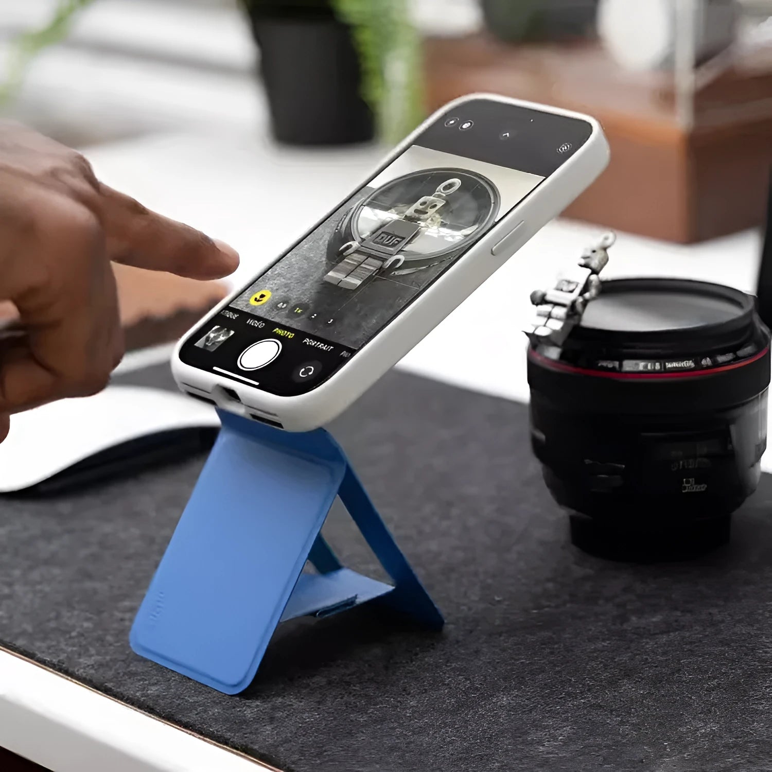 Magnetic mobile phone holder case in MOVAS plain leather showing four colour options: black, blue, green and grey