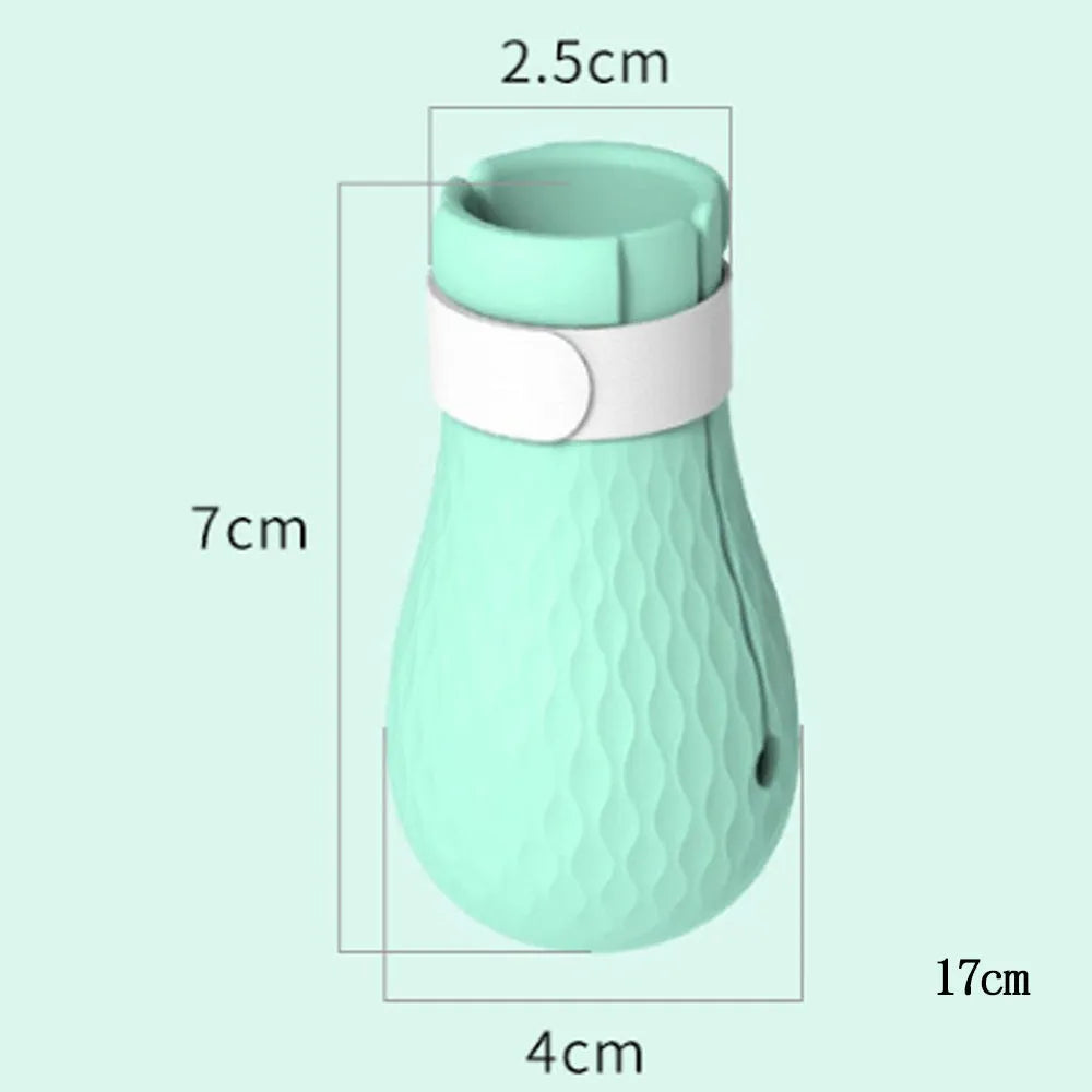 Green silicone cat paw covers with straps for scratch protection during washing and medical procedures