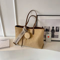 Soft large casual shoulder tote bag in a horizontal square shape with a sandwich pocket and sewing thread detail.