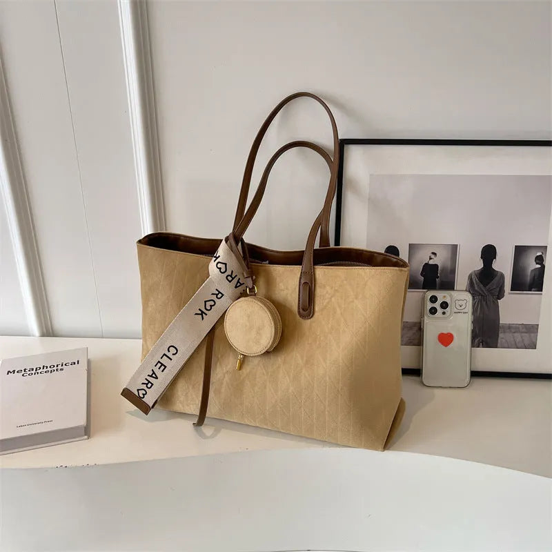 Soft large casual shoulder tote bag in a horizontal square shape with a sandwich pocket and sewing thread detail.
