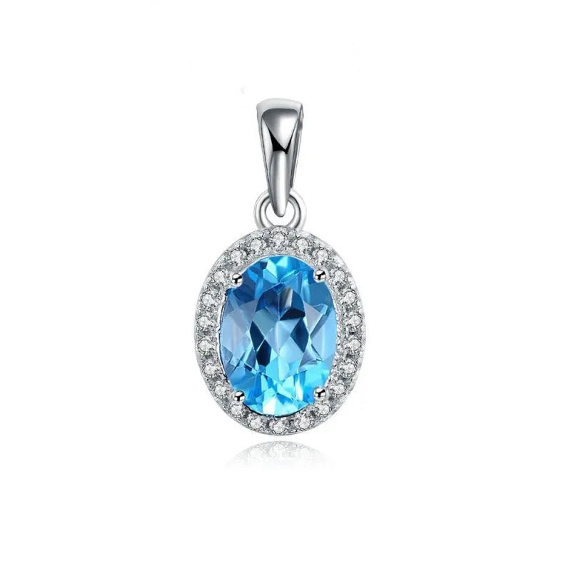 Four-piece sterling silver jewellery set with blue topaz stones: geometric earrings, ring, pendant, and necklace.
