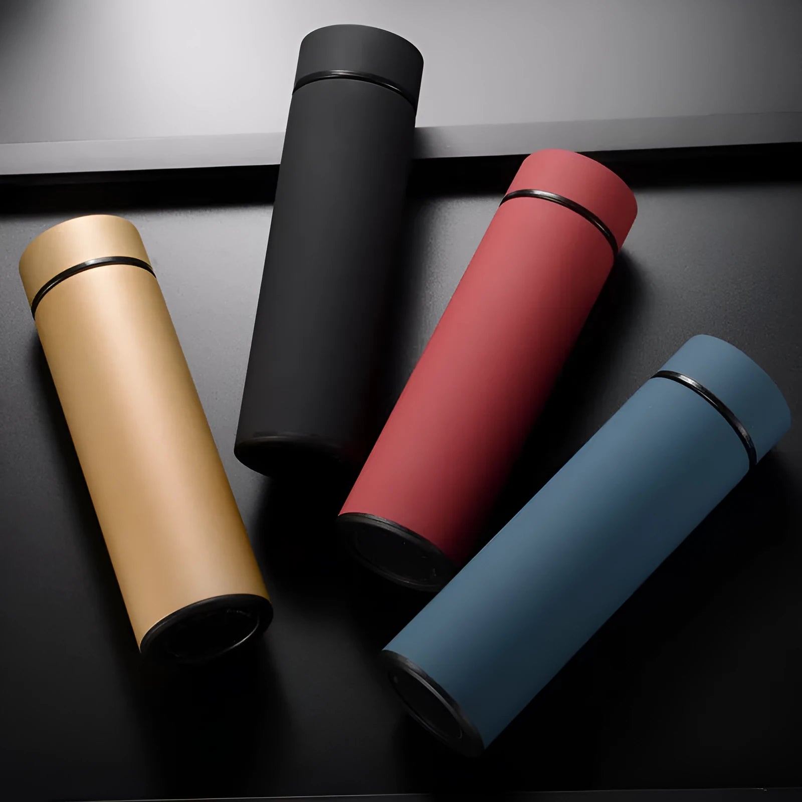 Stainless steel vacuum insulated water bottle in black, red, gold, or blue, 450ml capacity.