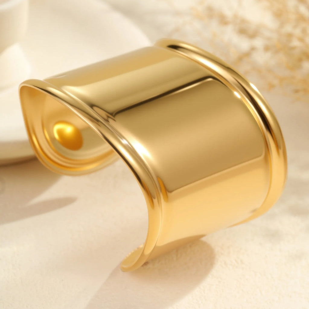 Women's wide wave design bracelet with geometric openings and gold plating finish