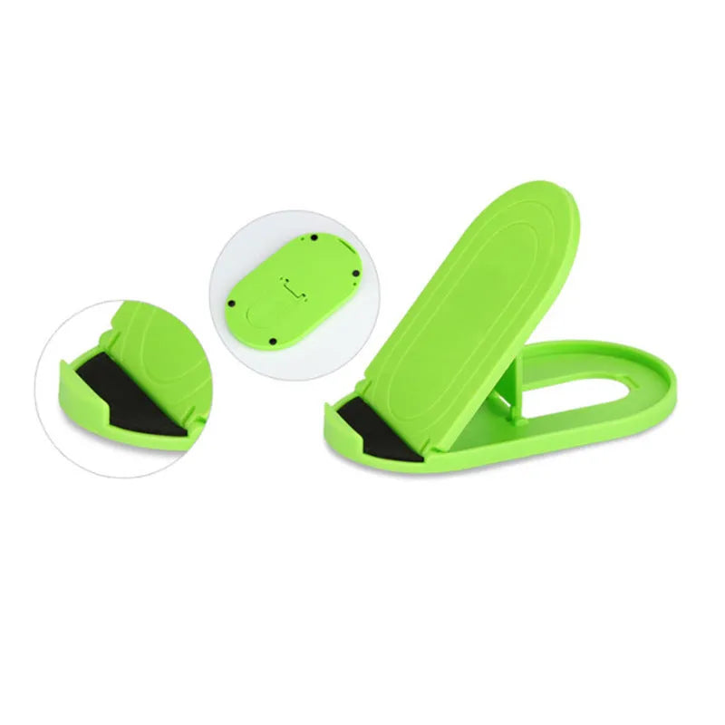 A plastic lazy bracket mobile phone stand on a table, shown in one of six available colours.