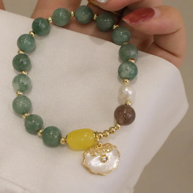 Women's fashion bracelet made from natural green jade shells on a casual background