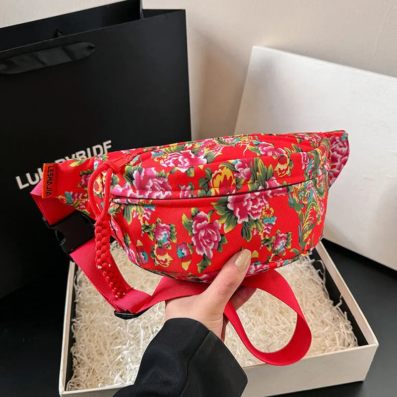 Women's Western-style floral waist bag in nylon with adjustable strap showing contrast stitching