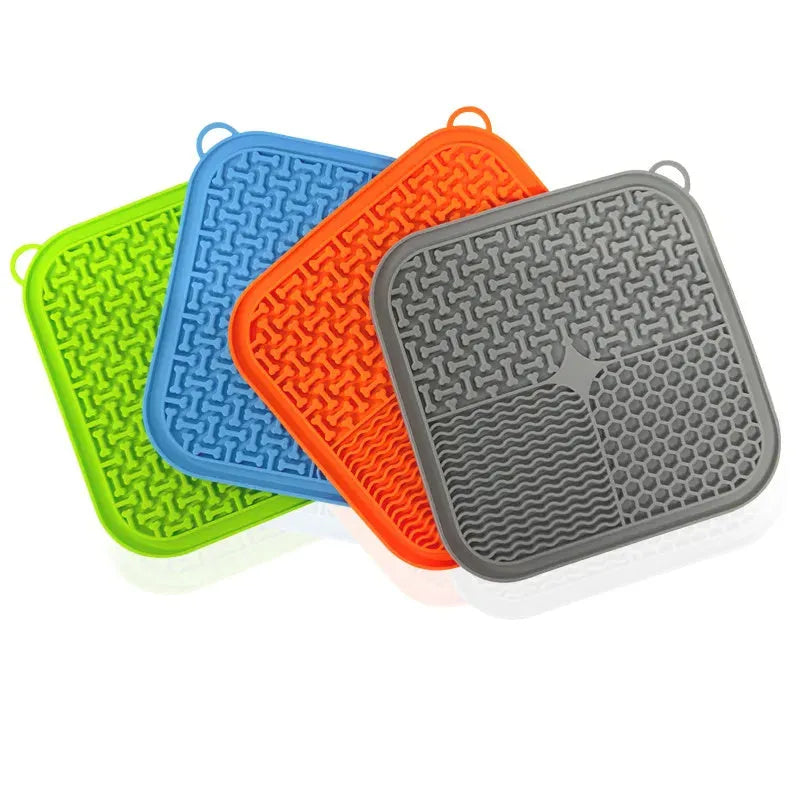 Orange and grey silicone dog lick mat with textured surface and suction cups on reverse side