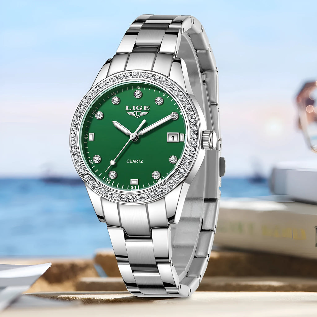 Silver fashion quartz watch for women with diamond-encrusted bezel and luminous dial on a 34mm stainless steel case.