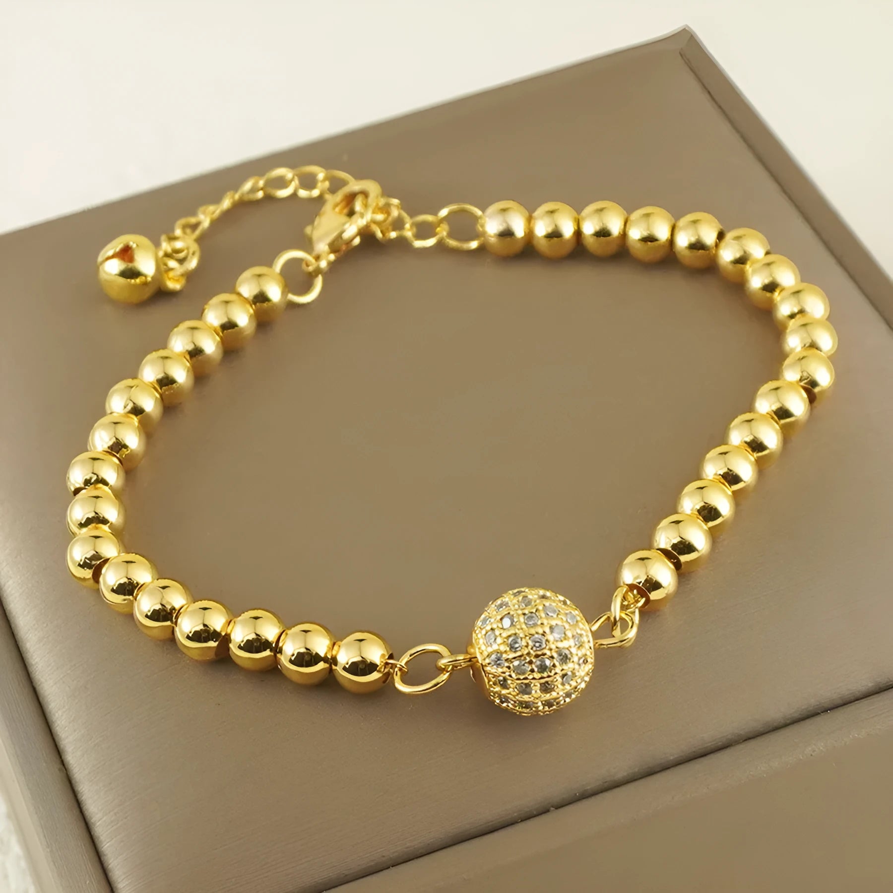 Women's heart-shaped copper bracelet with a single round zircon stone.