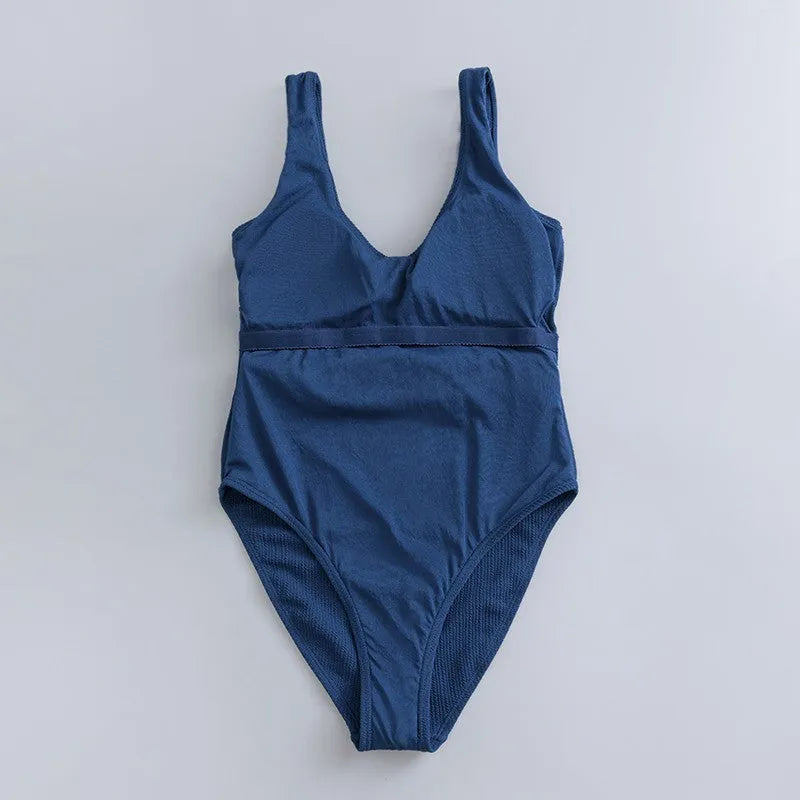 Navy blue women's one-piece swimsuit with chest padding and slim triangle design