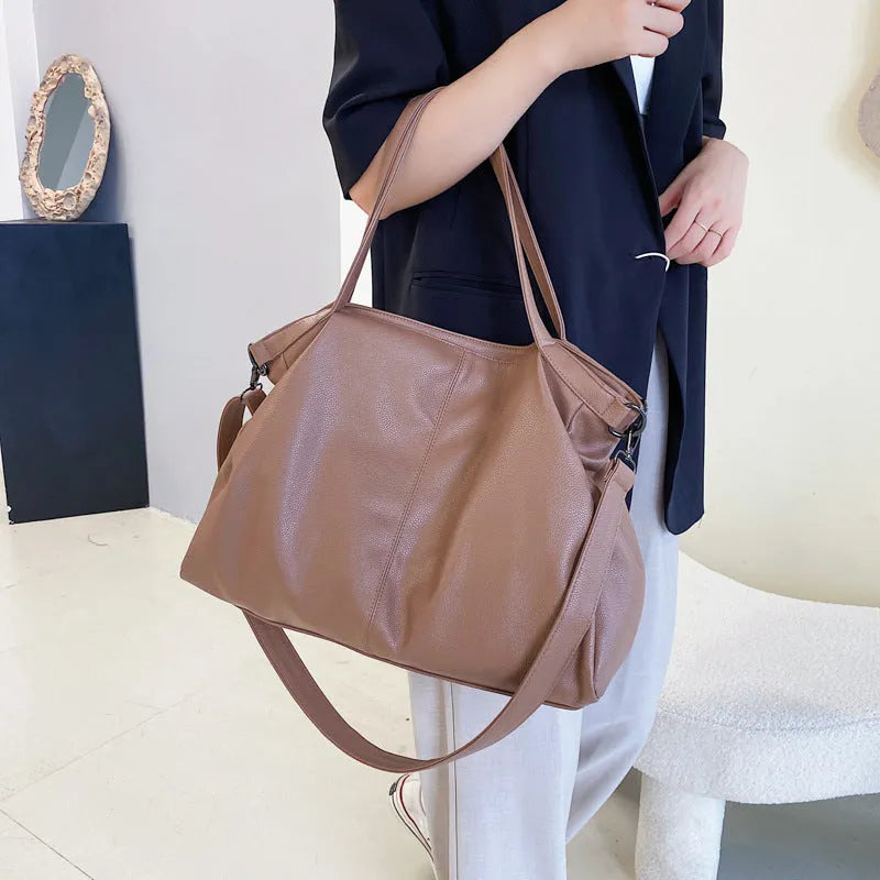 Large soft surface messenger bag in horizontal square shape with adjustable shoulder strap